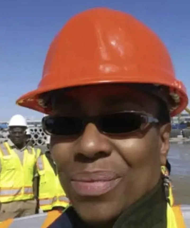 OSHA-certified safety trainer wearing a safety vest and blazer