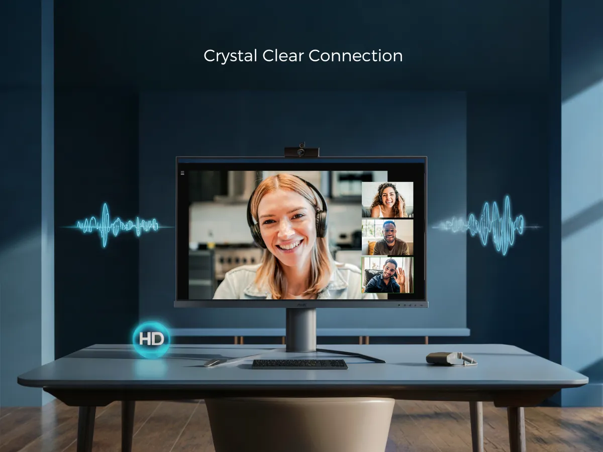 Image depicts a monitor on a desk showing a video call with four people. Text above reads "Crystal Clear Connection" with sound wave graphics on either side. The desk has a keyboard, a pen, a diary, and has a "HD" icon floating near the bottom left corner.