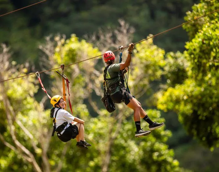 2 girls ziplining at Kualoa Ranch