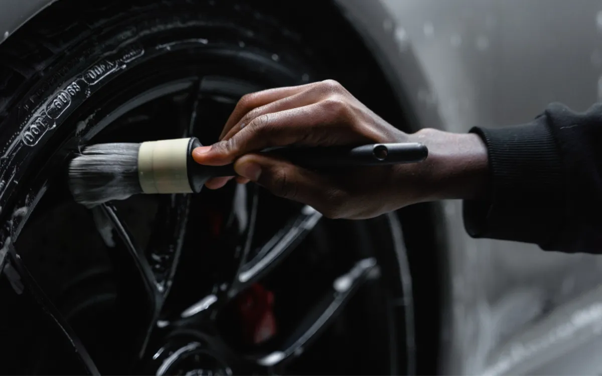 A man applying a ceramic coat on a car