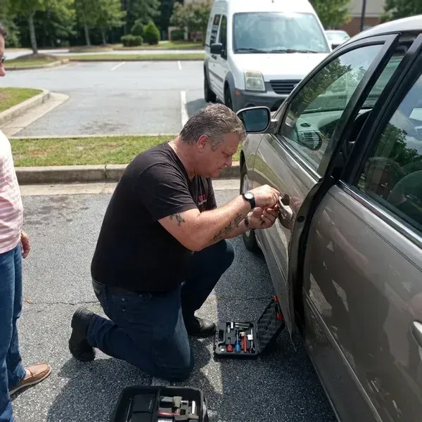 911 Lock and Door technician unlocking a customer's car during a routine automotive lockout in Douglasville, GA