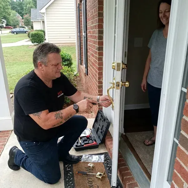 911 Lock and Door technician installing a new home lock for a Douglasville family