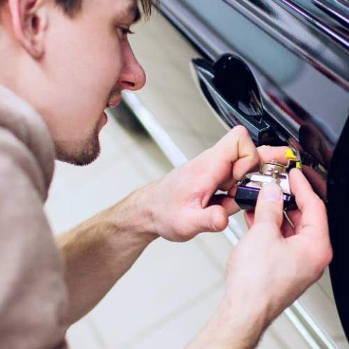 an automotive locksmith unlocks a driver's car door in Douglasville, GA