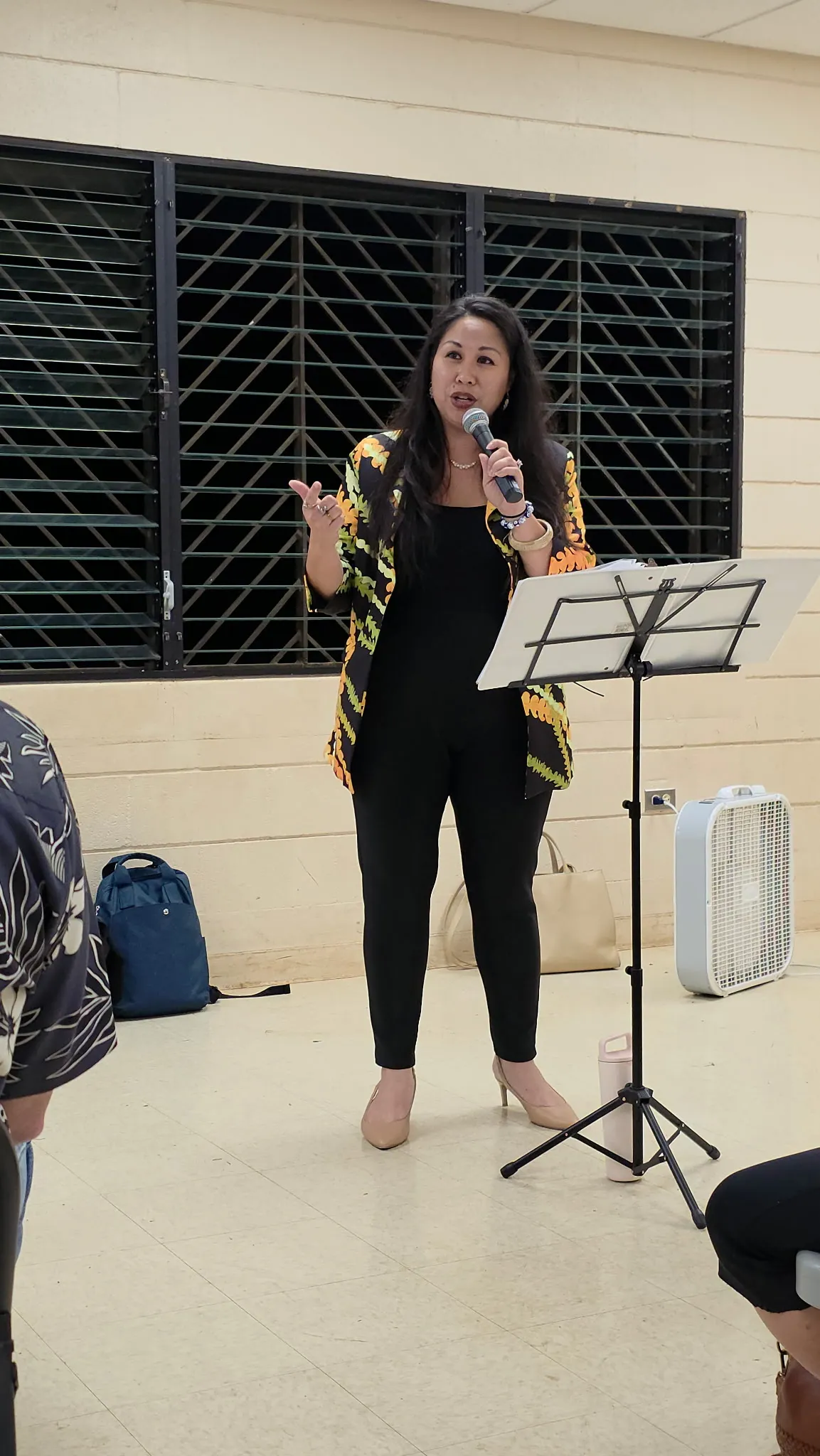 Dr. Darcie Pulawa-Morales speaking live with a microphone