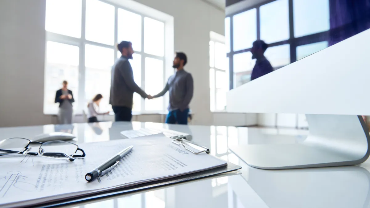 High-resolution image of an aquaponics greenhouse installation in a Latin American rural school, workers installing tanks, seedlings in trays, bright natural light, demonstrating scalable food-security tech in community settings.