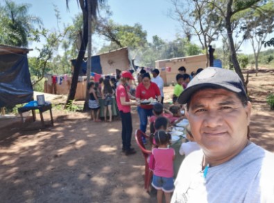 Overlapping landscape photo of a cooperative water-harvesting project with a multi-generational team inspecting systems at sunset, warm tones, high-quality editorial photography showing long-term vision and collaboration.