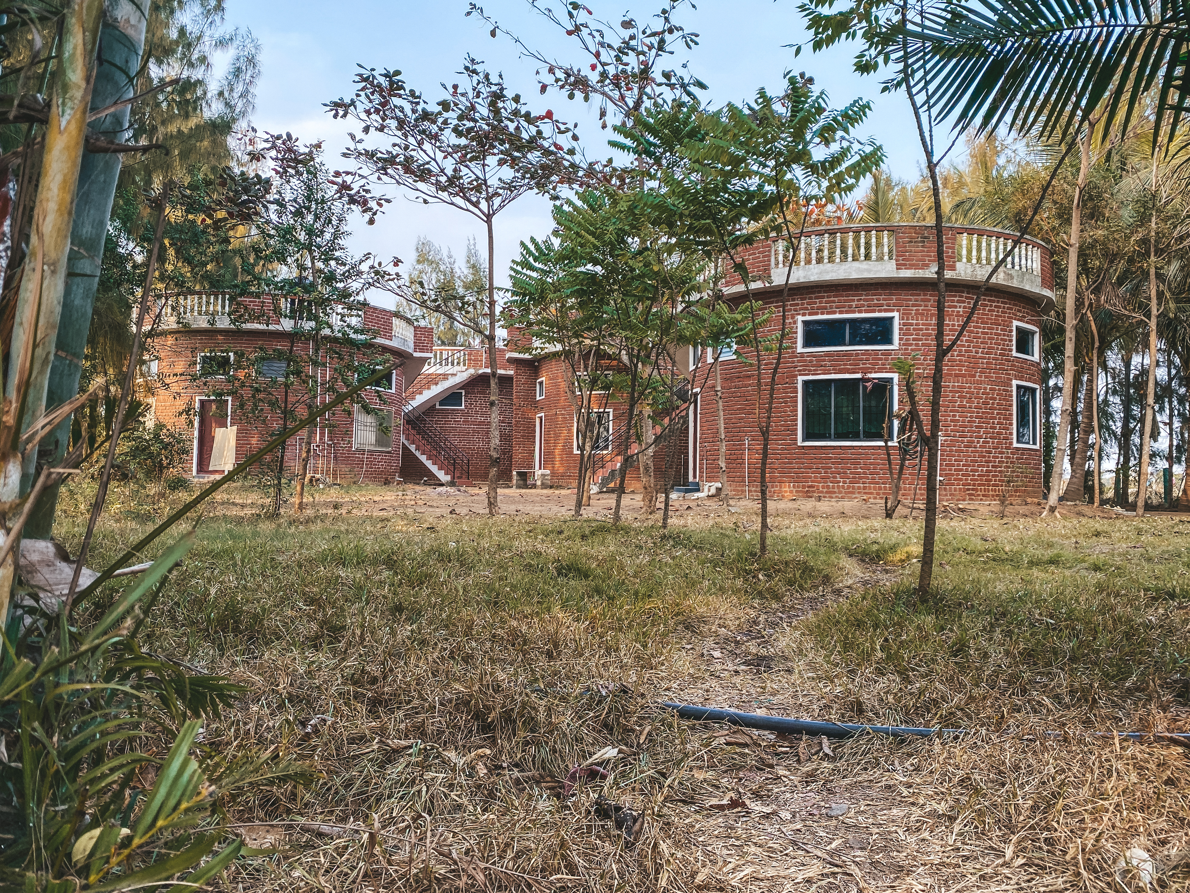 Overlapping landscape photo of a cooperative water-harvesting project with a multi-generational team inspecting systems at sunset, warm tones, high-quality editorial photography showing long-term vision and collaboration.