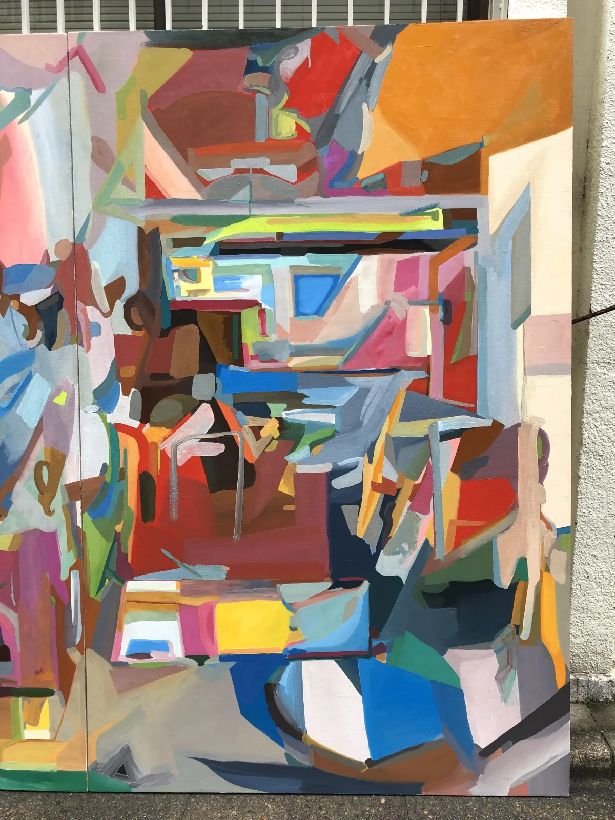 A candid group photo of a multicultural team of designers and strategists in a modern office, smiling and collaborating, with creative tools and digital screens in the background.