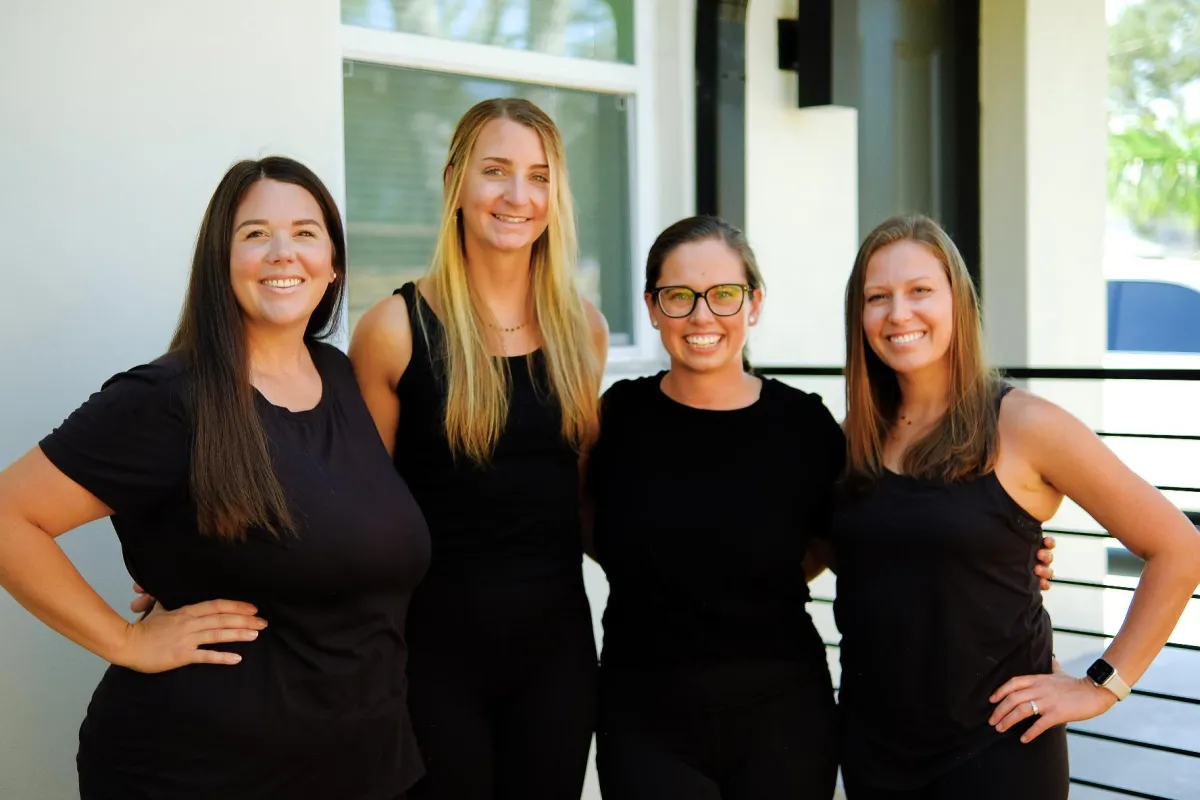 selective focus photography of woman holding yellow petaled flowers
