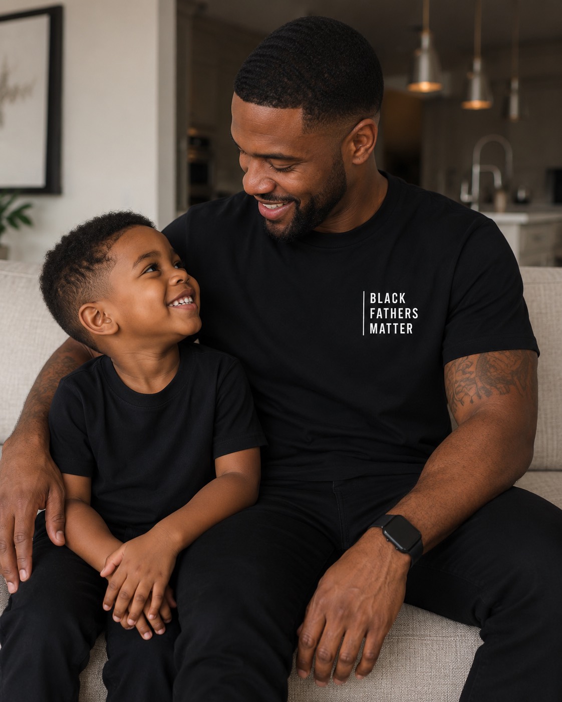 A powerful black and white portrait of a Black father and child