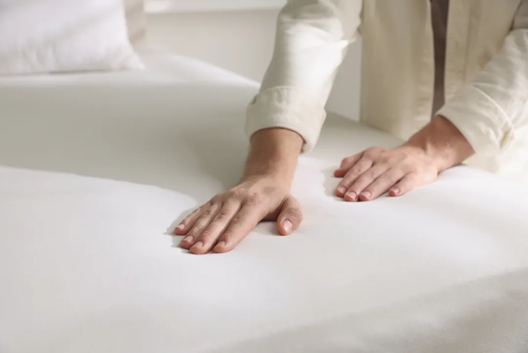 SomniLux delivery team unboxing a mattress at a customer's doorway; friendly staff in uniform, clean packaging; photorealistic image demonstrating the white-glove experience.