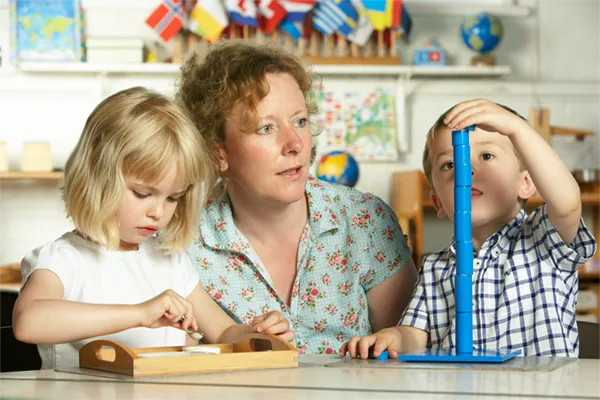 two young girls coloring in book