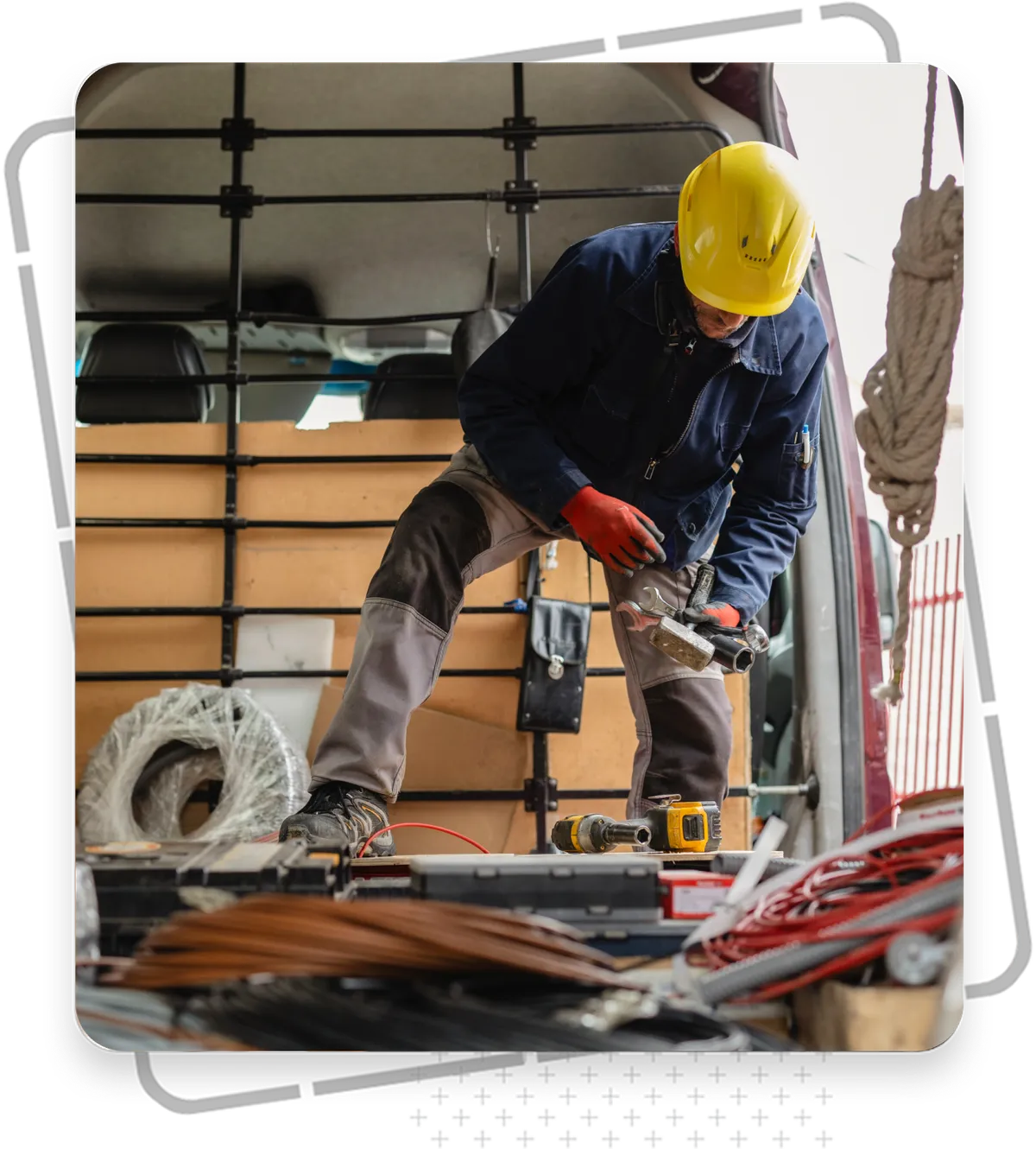 Tradesman working in his van, tools and materials visible around him