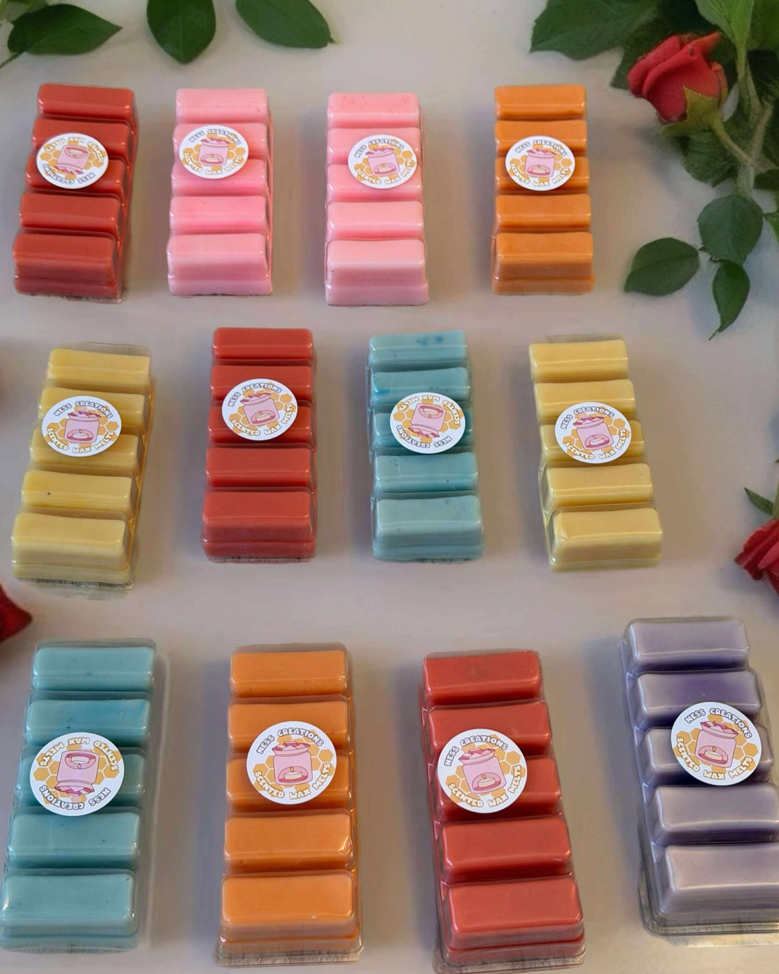 12 different wax melt bars in 3 rows of 4, all different colours and scents