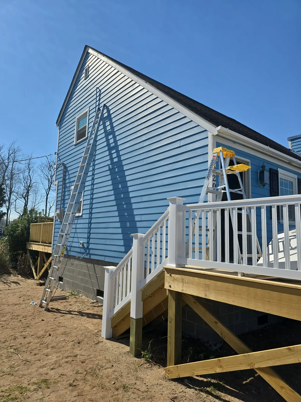 Blue siding and white porch rail on a Morehead City home