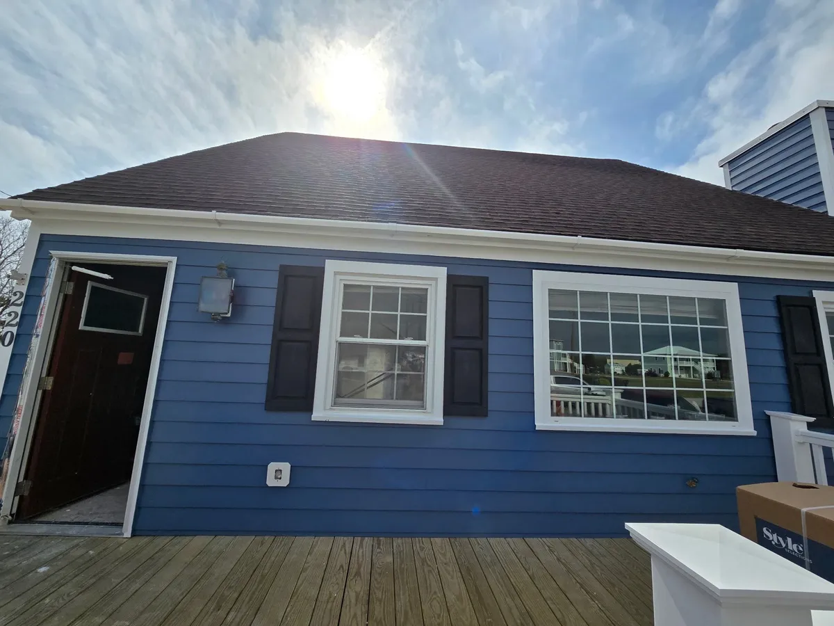 Completed exterior repaint on a blue coastal home