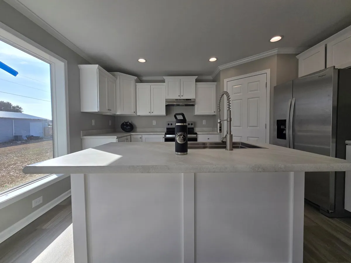 Bright open kitchen and living area after painting