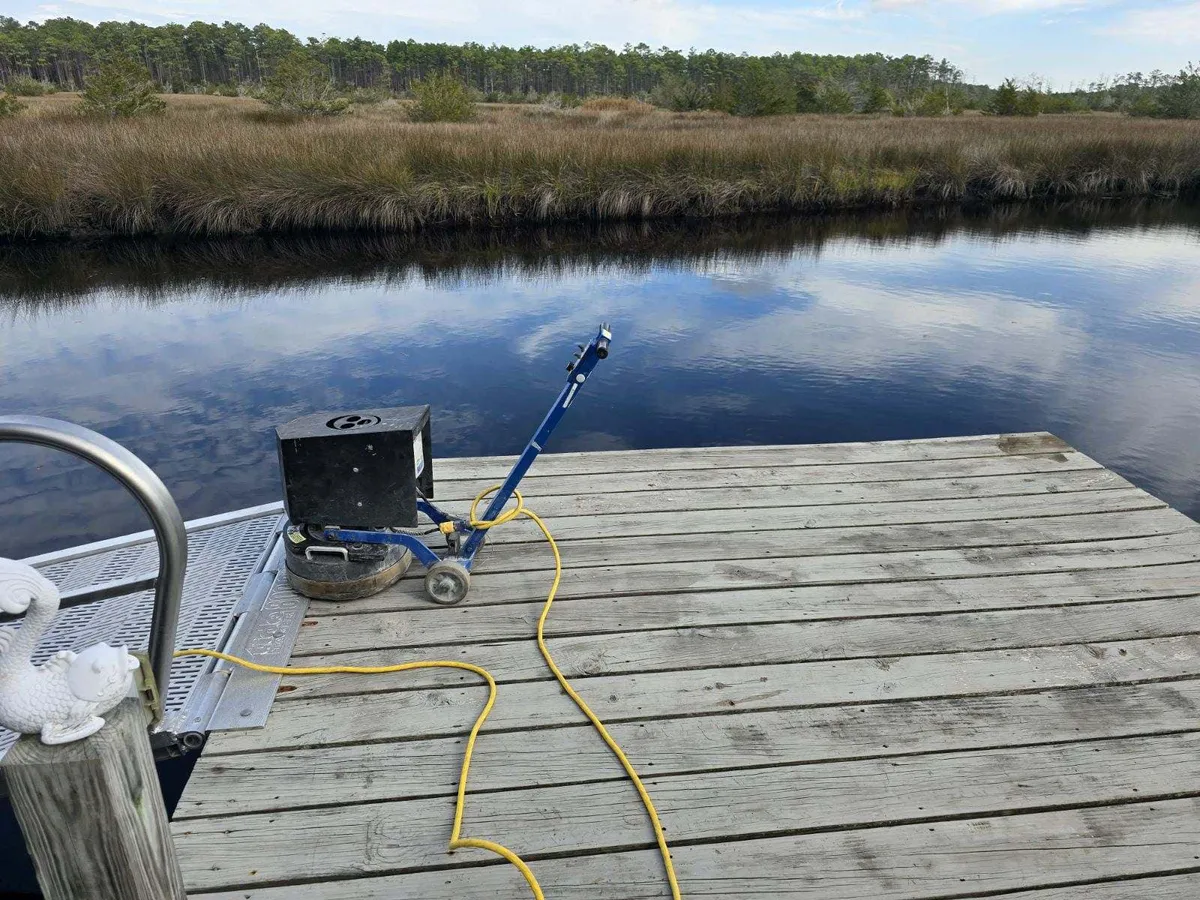 Weathered dock over the water before power washing in Atlantic Beach NC