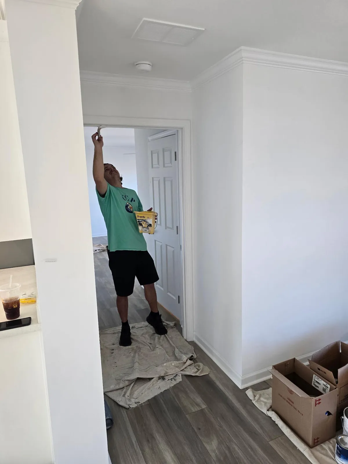Cook's Coastal Painting crew member painting an interior wall