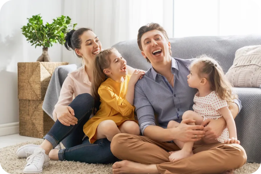 Happy family relaxing together in their living room, representing the peace of mind and stress-free experience provided by professional home inspection services in Nashville and Middle Tennessee.