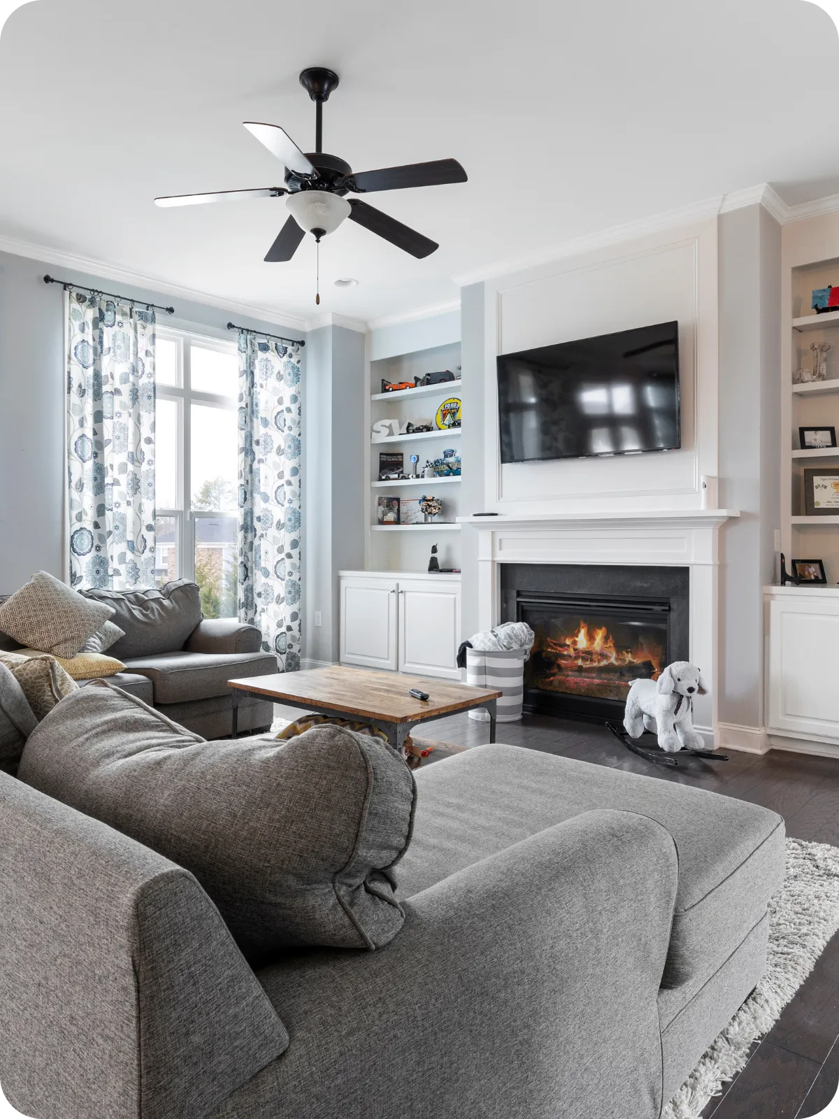 Bright, modern living room with fireplace, built-in shelving, and large windows, representing the interior spaces evaluated during pre-listing home inspections in Nashville and Middle Tennessee.