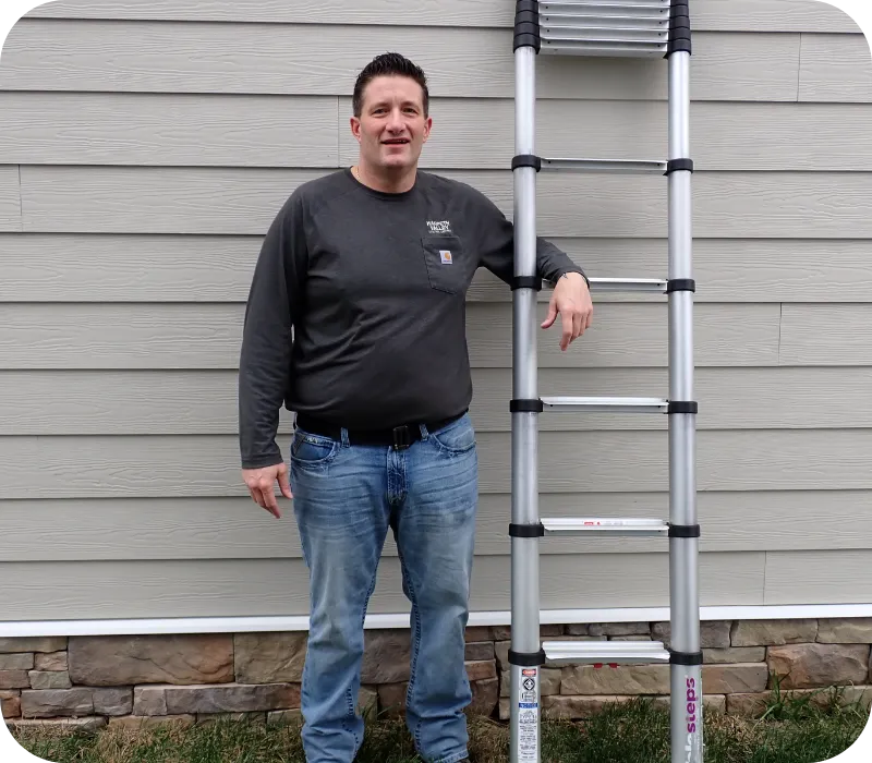 Home inspector standing beside an extension ladder outside a residential property, representing professional home inspection services in Nashville and Middle Tennessee.