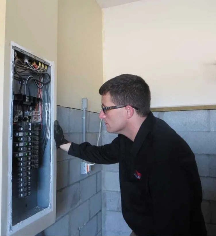 Home inspector reviewing a home's electrical panel during a detailed residential inspection, representing professional home inspection services in Nashville and Middle Tennessee.