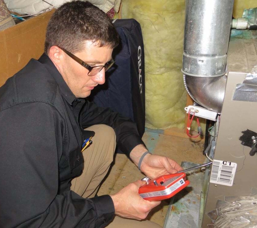 Licensed home inspector testing a residential HVAC furnace during a professional home inspection