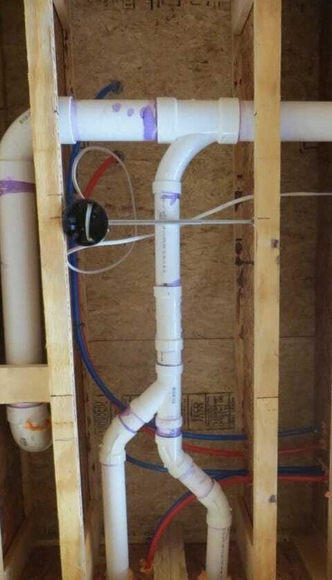 Pre-drywall inspection showing exposed plumbing and framing during a new construction home inspection