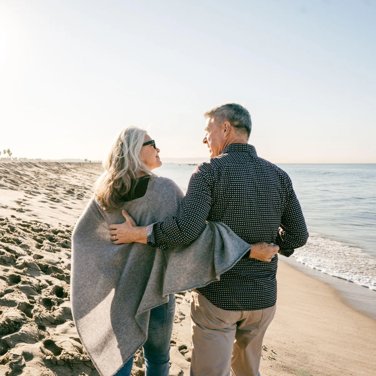 Senior couple walking on bech