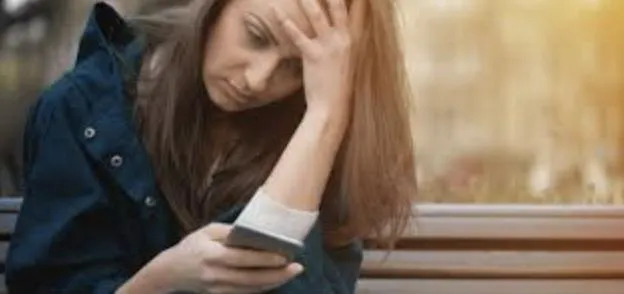 woman in black sweater holding white and black vr goggles