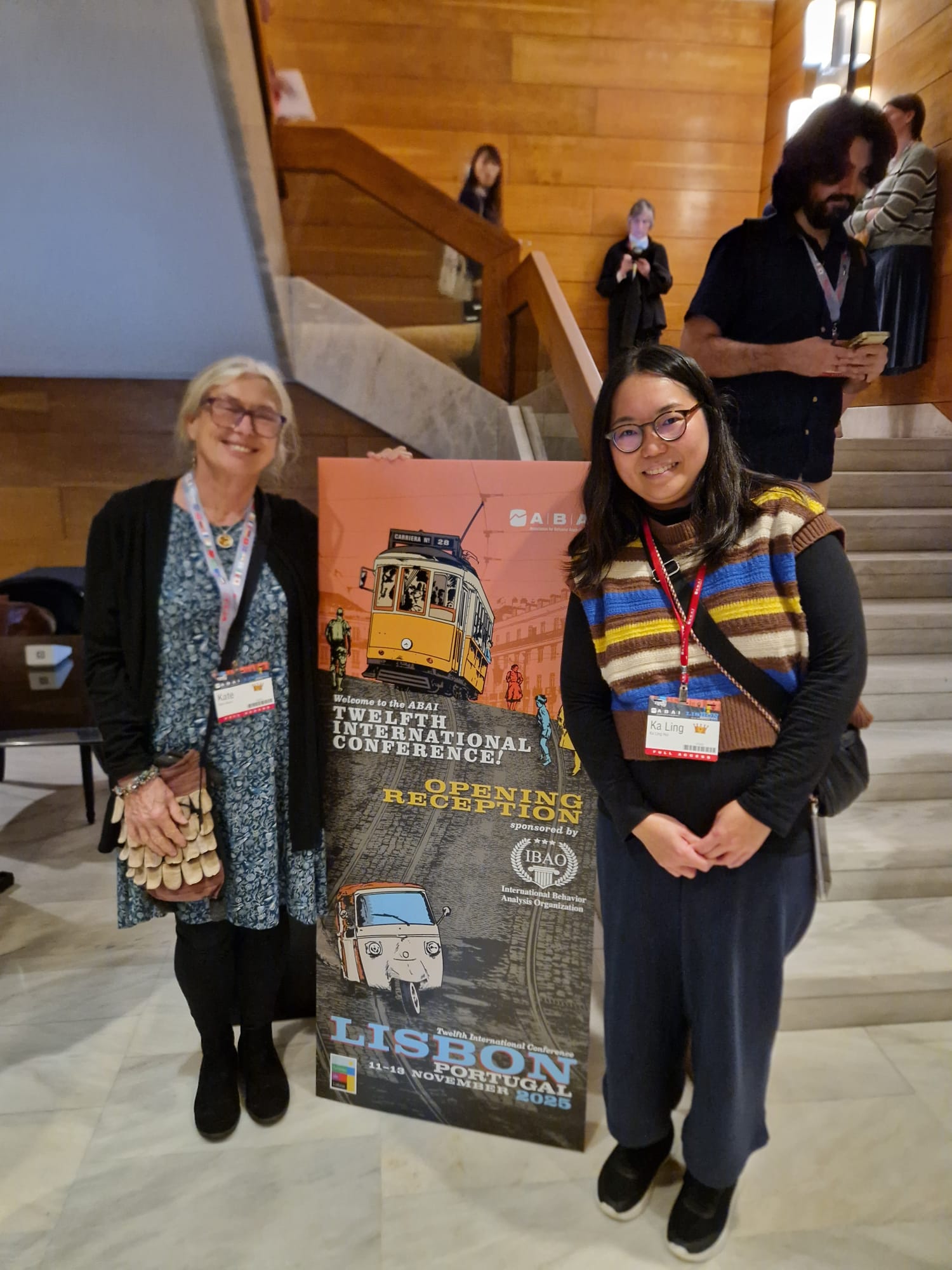 A cheerful woman in her 30s, holding a glowing star-shaped light, standing in front of a colourful mural featuring abstract educational icons, Bristol cityscape faintly visible through a window, 1:1 aspect ratio.