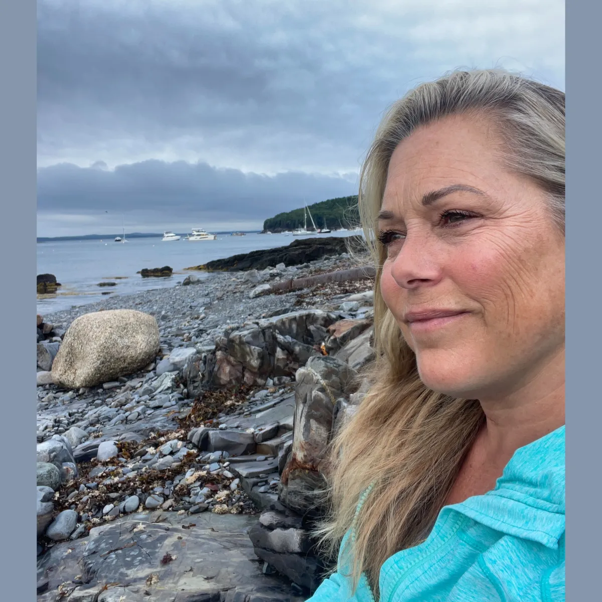 Image of Pasha in a reflective, contemplative state on Maine's rocky coast
