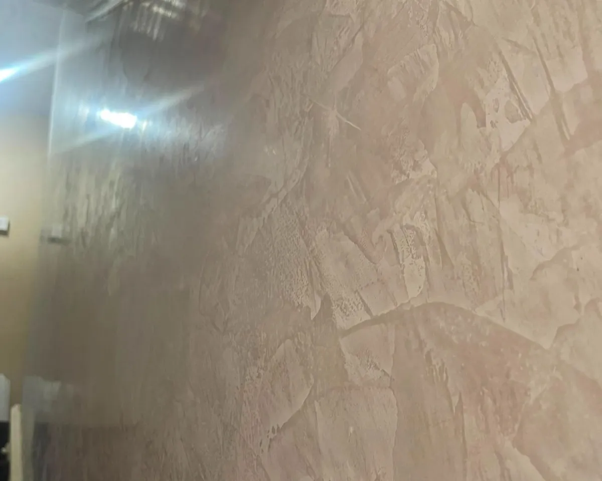 Concrete effect plastering in Bishopsworth giving a kitchen wall a soft mottled grey finish
