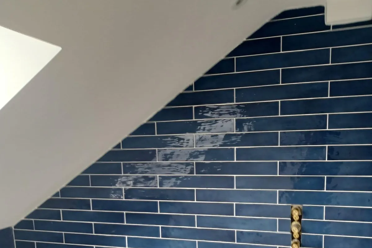 Tile replacement in Bishopsworth with a cracked wall tile being cut out and replaced