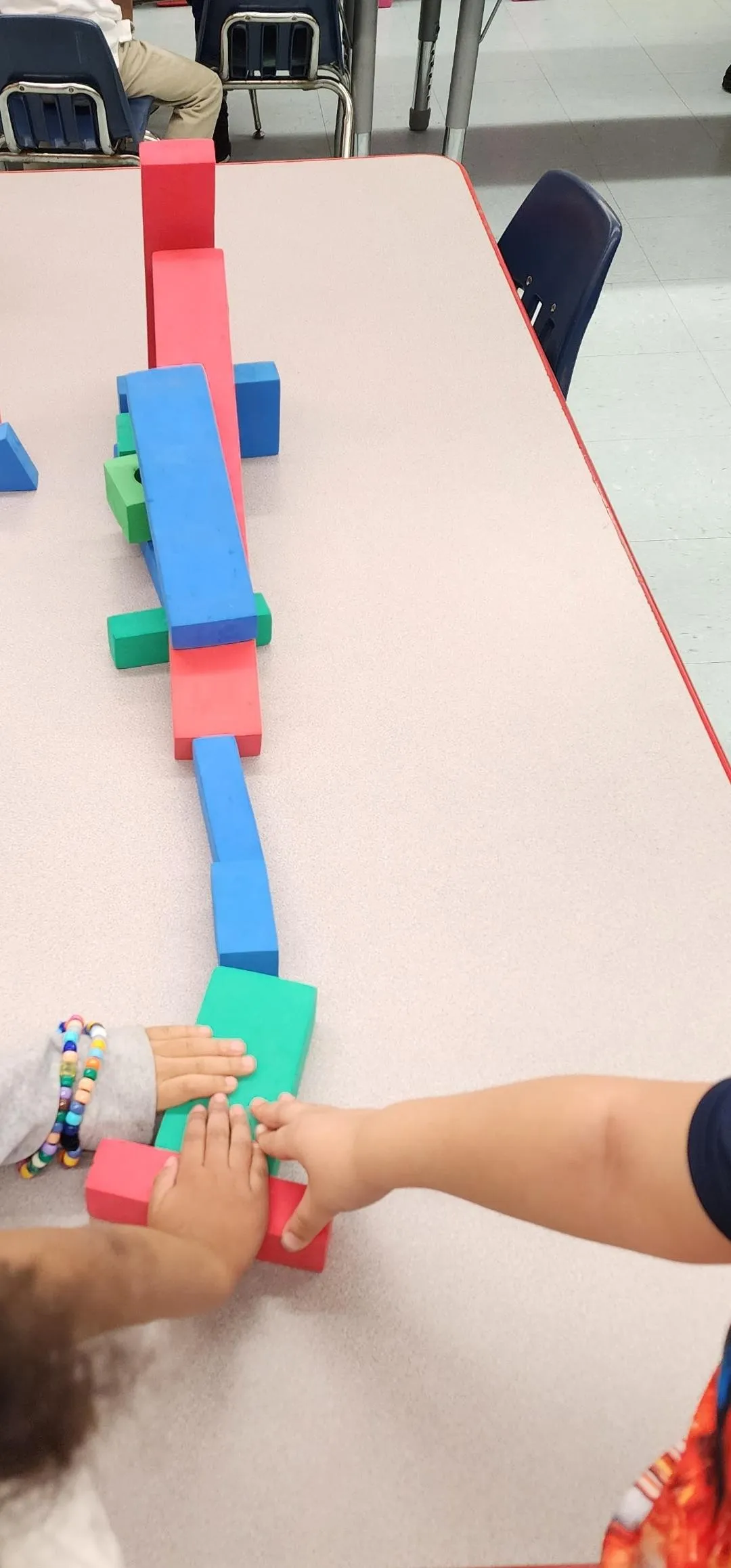 Boy picks paper out of different colored liquids