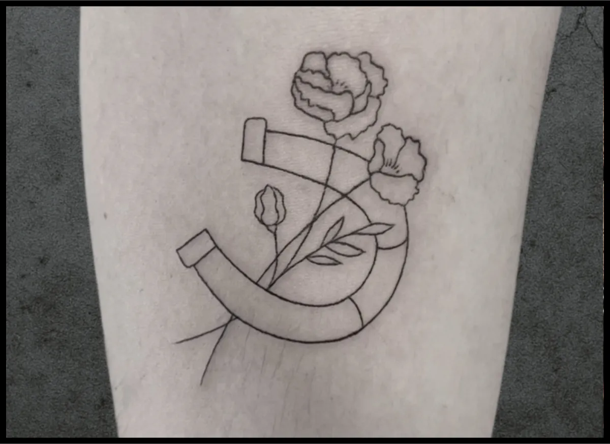 Horse with flowers tattoo on arm