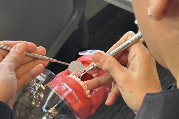 Dental assistant student in a hands-on training course at Dental AssistEd in Chicago, Illinois
