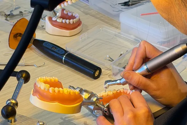 Dental assistant student practicing hands-on clinical techniques on a dental training model during a course at Dental AssistEd in Chicago, Illinois
