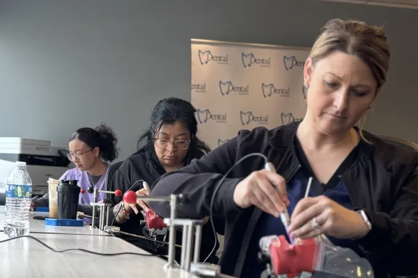 Dental assistant students practicing hands-on clinical skills on dental training models during the 8-week Become a Dental Assistant program at Dental AssistEd in Chicago, Illinois