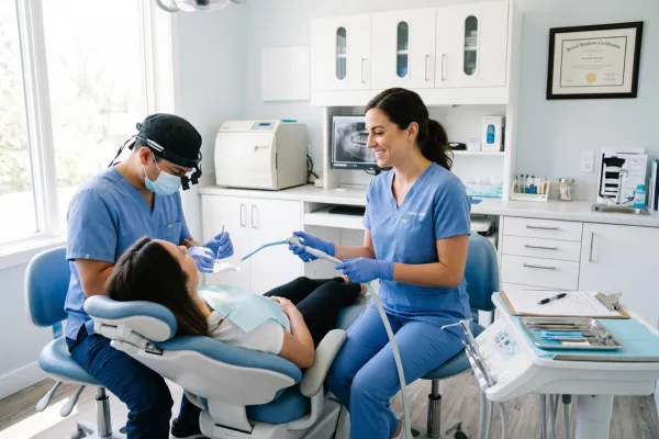 Dental AssistEd dental assistant working chairside with a dentist in a Chicago dental office, illustrating certification and career growth for Illinois and Indiana dental assistants