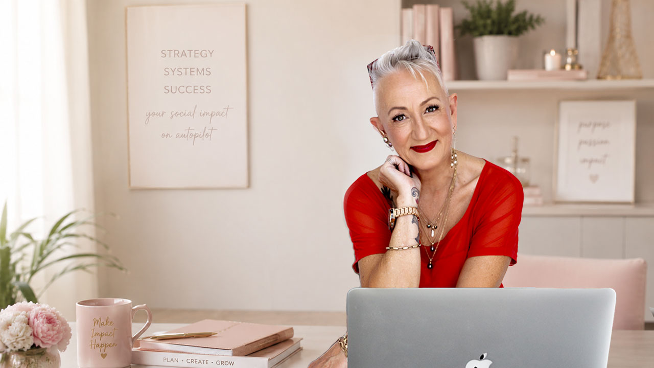 Ursula Hurn, social media mentor, working on a laptop and helping small business owners simplify their content systems.