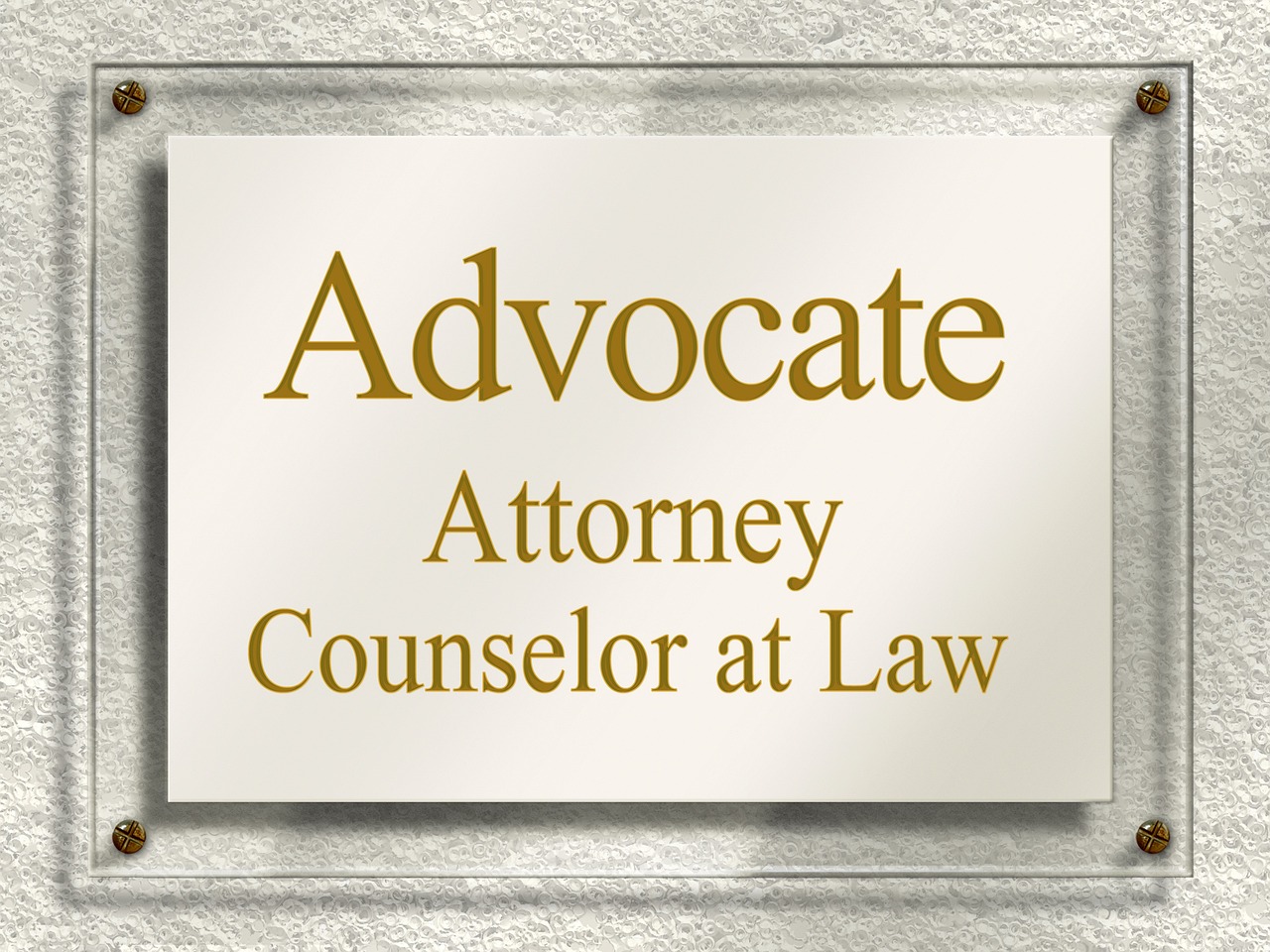 Plaque on a wall reading “Advocate Attorney Counselor at Law,” symbolizing legal services and professional law firms.