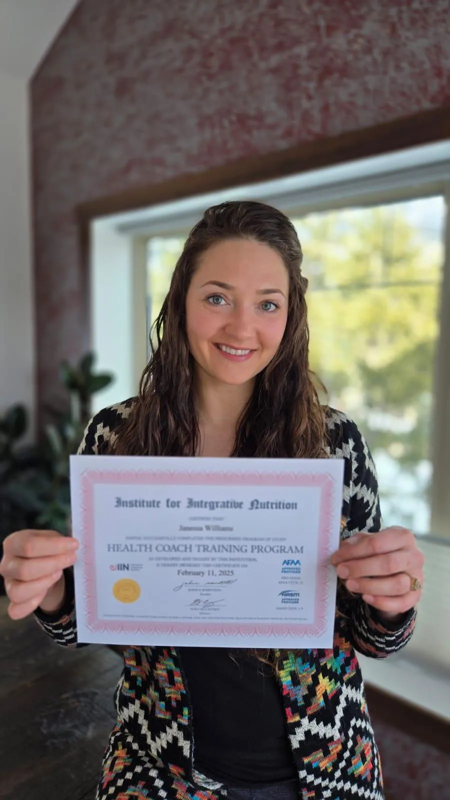 Janessa Williams Registered Massage Therapist and Board Certified Health Coach with her health coach training program certificate