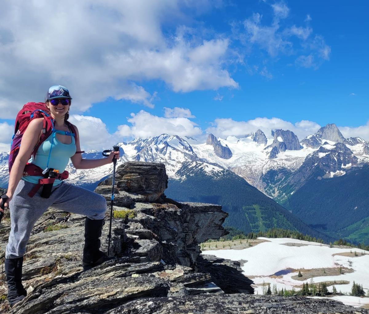woman hiking in mountains representing pain-free movement and recovery