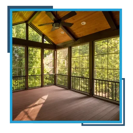 Screen porch construction with wood ceiling and large windows overlooking a lush outdoor area.