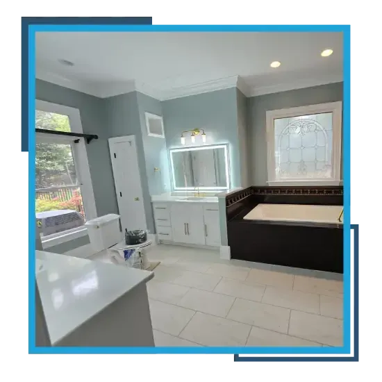 Remodeled bathroom with white vanity, mirror, and tile flooring showcasing RSB Services LLC renovation work.