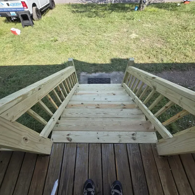 Newly built wooden deck stairs and railing by RSB Services LLC in Durham, NC.