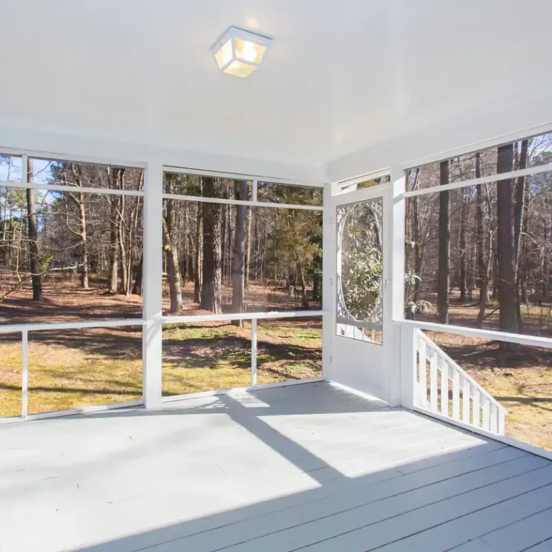 Screened porch in Raleigh, NC with wooded view and comfortable outdoor living space.