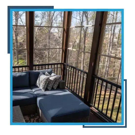Screened porch with comfortable seating overlooking a wooded backyard in Raleigh, NC.